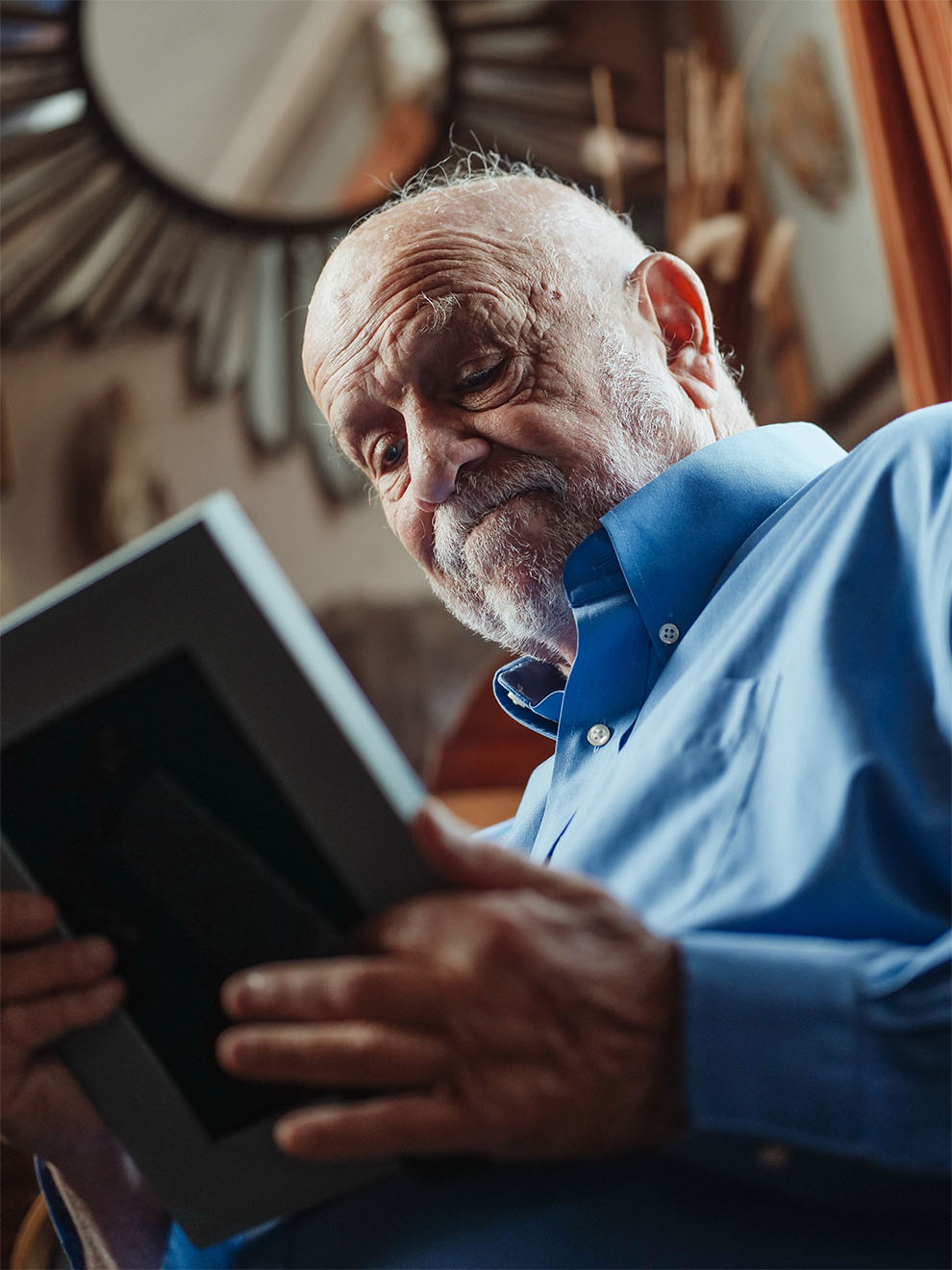 Elderly Man Looking at Photograph