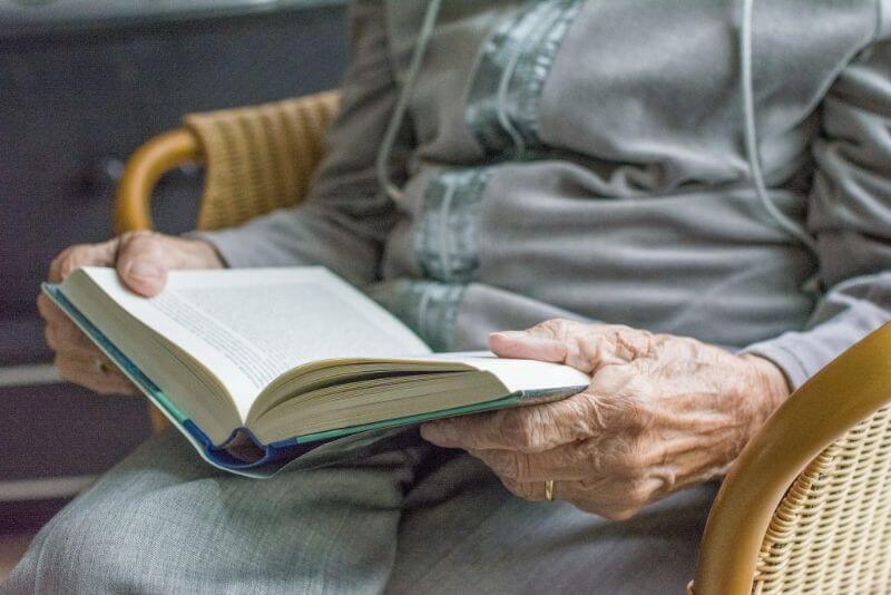 Elderly Person Reading Book