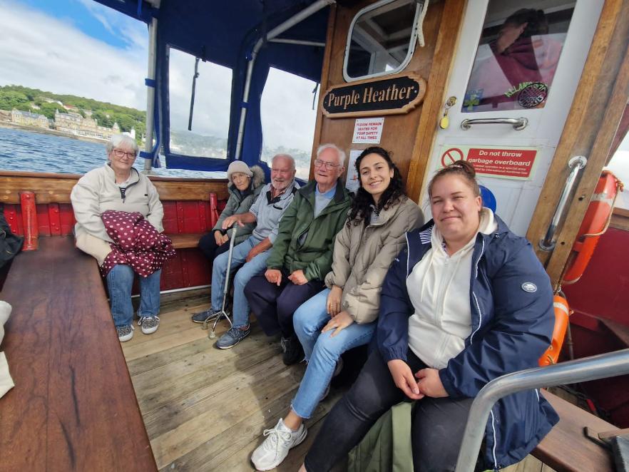 residents on a boat smiling during a trip to oban