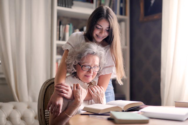 grandparent with granddaughter hugging her