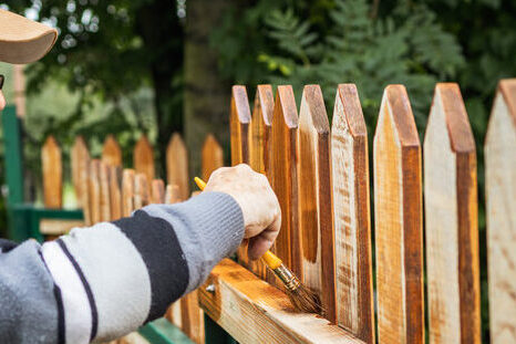 man painting fence